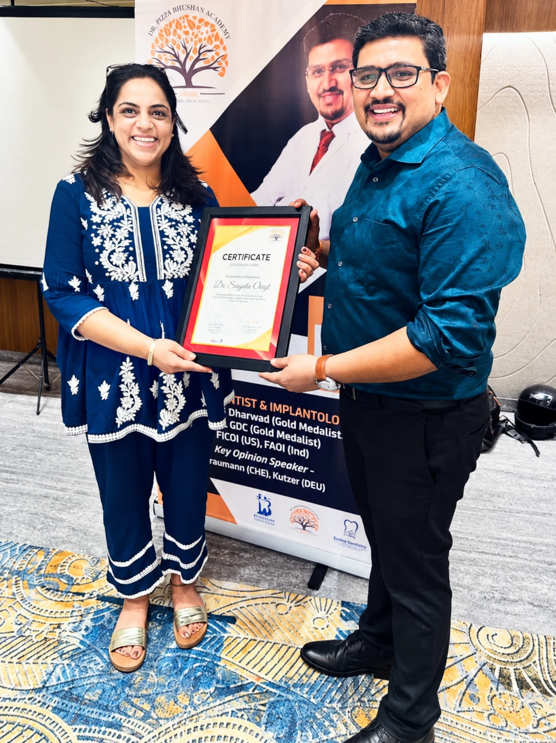 Dr. Sangeeta Chugh receiving a framed certificate at a professional event