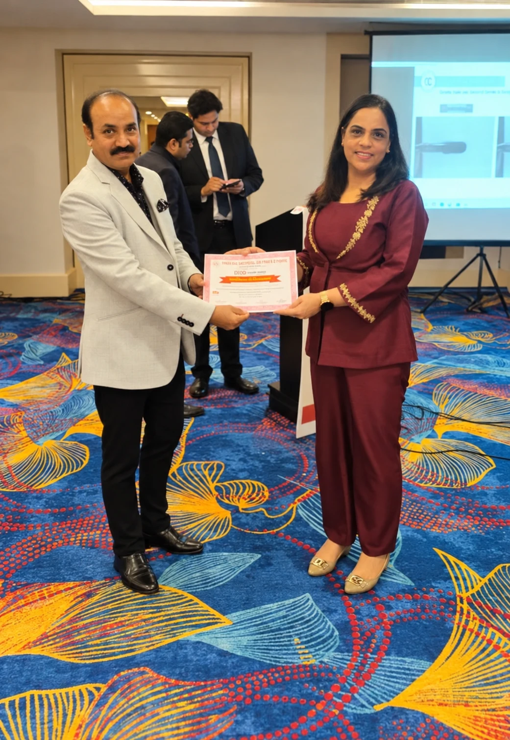 Dr. Sangeeta Chugh receiving a certificate at a recognition ceremony